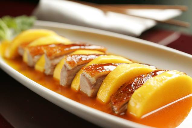 Pato laqueado intercalado com fatias de manga fresca de estilo contemporâneo Pato laqueado intercalado com fatias de manga fresca de estilo contemporâneo