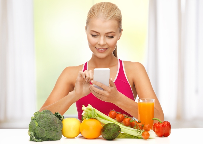 woman with fruits, vegetables and smartphone