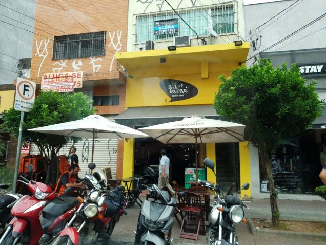A fachada com mesinhas na calçada A fachada com mesinhas na calçada