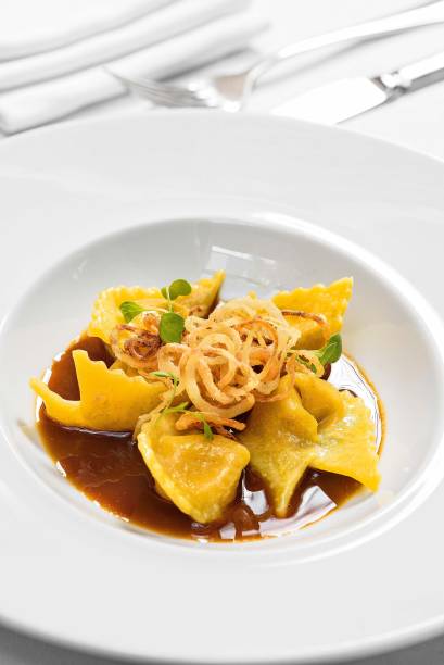 Ravióli de queijo curado: ao molho de cogumelos e com cebola crocante Ravióli de queijo curado: ao molho de cogumelos e com cebola crocante