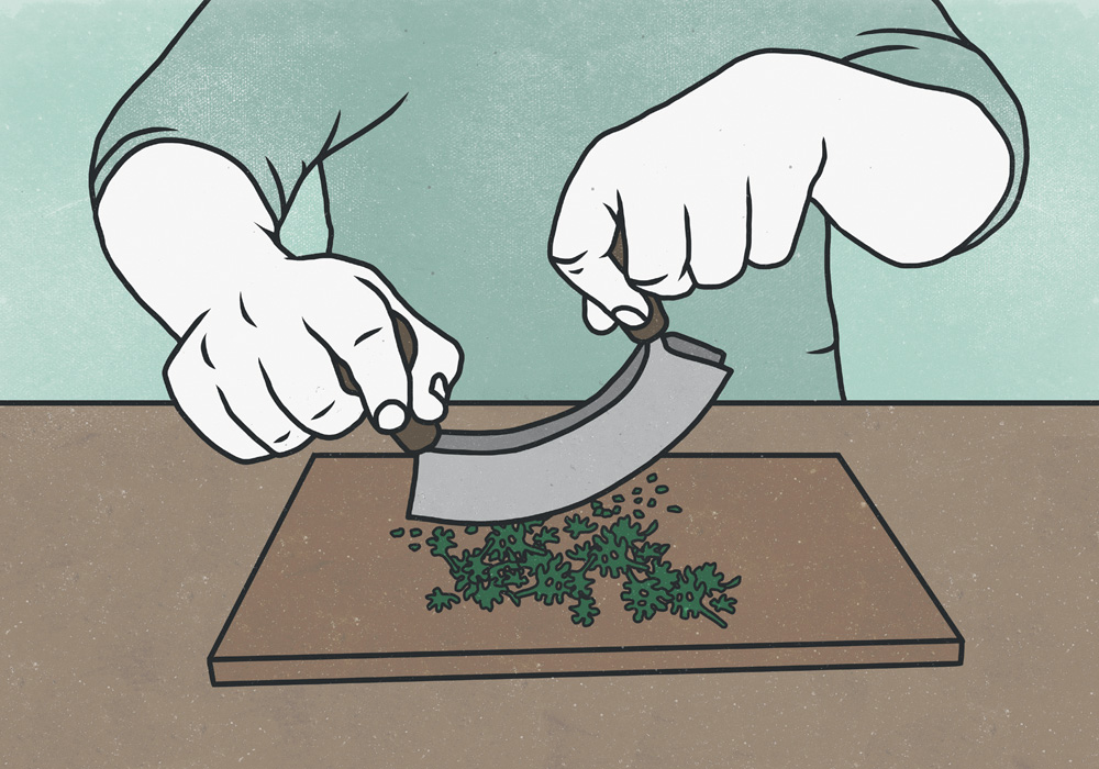 Midsection of man cutting herbs with mincing knife on chopping board Apetrechos de cozinha ajudam a economizar tempo no preparo dos alimentos.