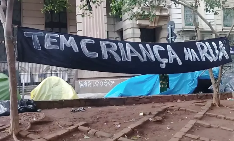 Em frente a um prédio no centro de São Paulo, uma placa com o escrito: 