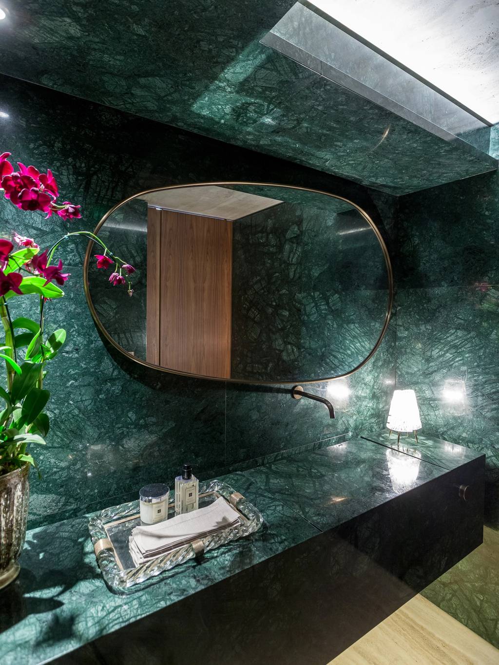 Estante com iluminação cênica é a protagonista deste apê de 815 m²